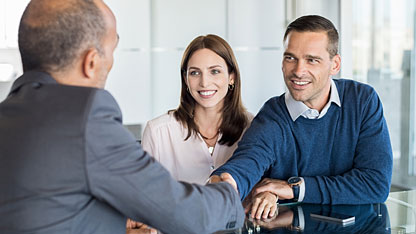 Businessman shaking hands with clients