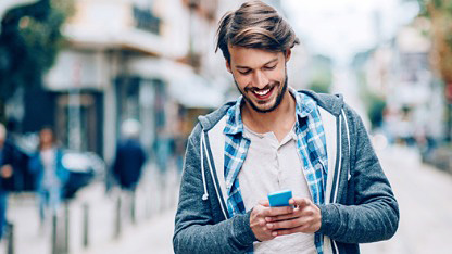 Man using mobile phone in street