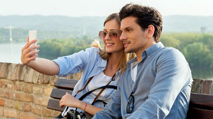 Couple on holiday taking photograph