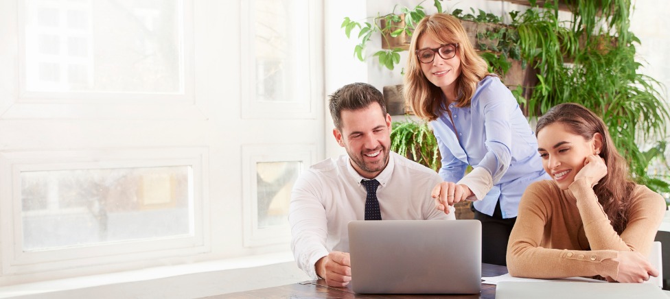 Mortgage Broker showing clients information on laptop