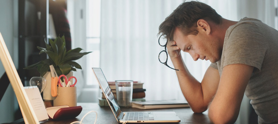 Concerned man using laptop