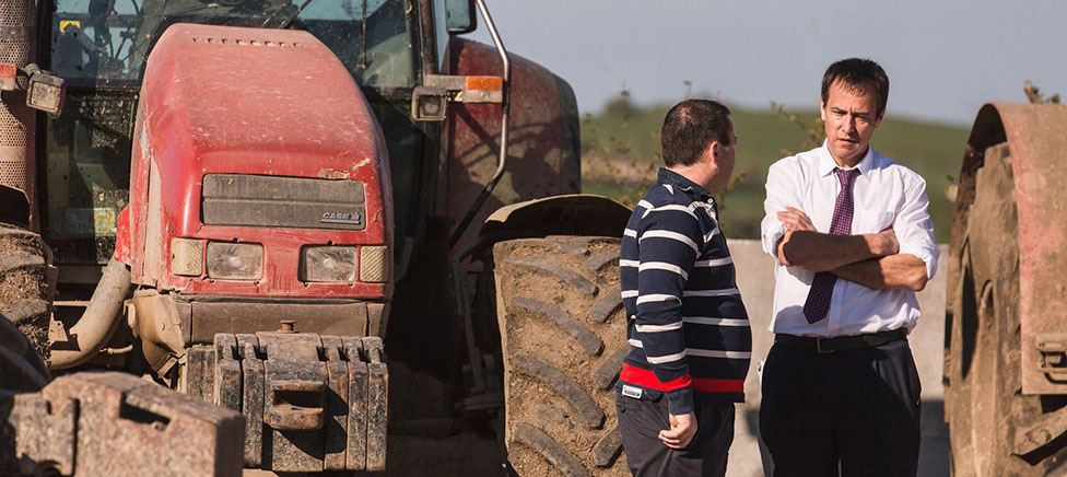 Business relationship manager visits farmer