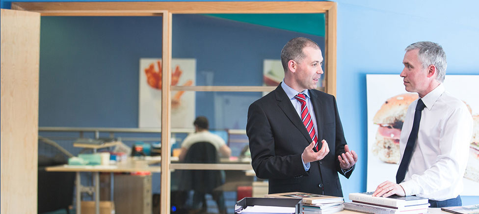 Businessmen talking in office