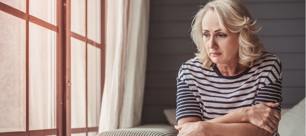 Sad woman sitting on sofa